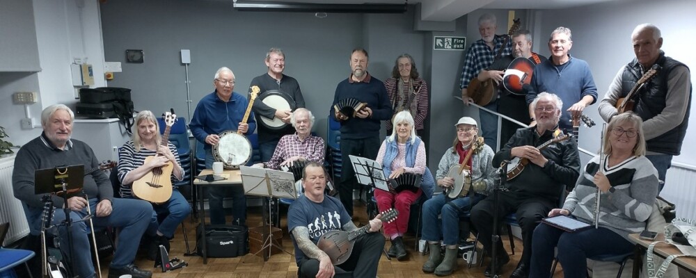 A photograph or the slow and easy folk band group with their instruments.