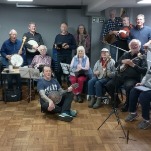 A photograph or the slow and easy folk band group with their instruments. 
