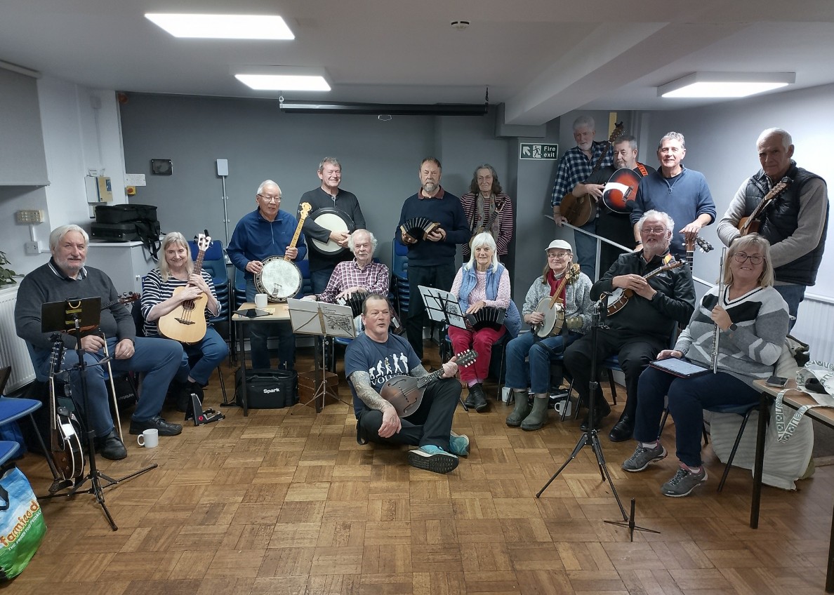 A photograph or the slow and easy folk band group with their instruments.